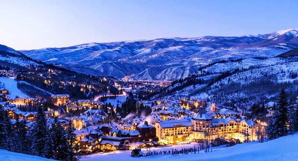 Colorado ski resort with snow-covered peaks and luxury mountain lodges 2025